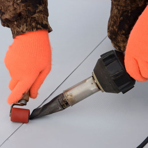 Commercial roofer applies TPO.